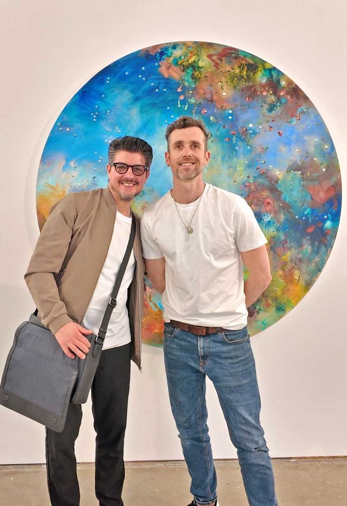 Thomas Chard with Chris Rivers in front of one of his cosmic blue circular paintings at Supernova II, Pontone Gallery, April 2026