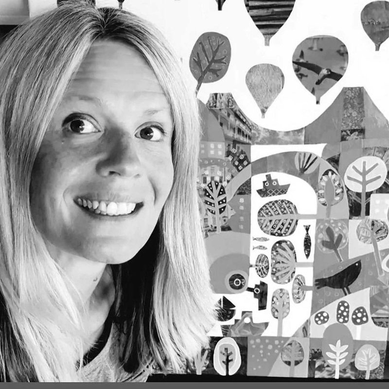 Jenny Urquhart in close-up, smiling, in front of one of her cut-paper Bristol cityscapes featuring leaves, balloons, ships, fish and birds